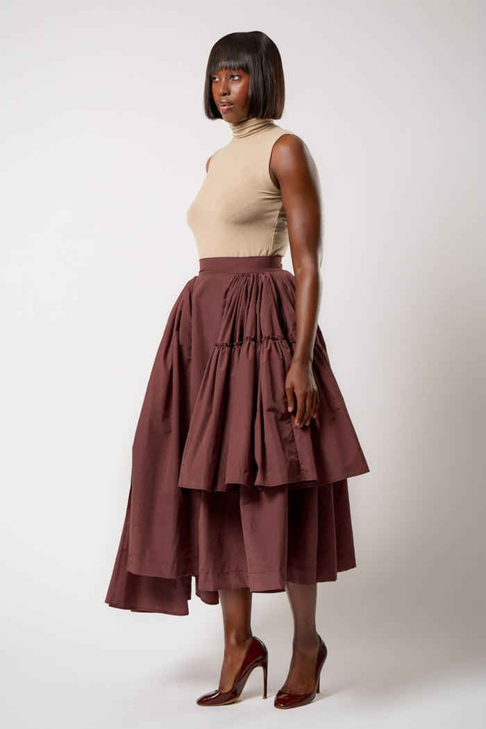 CALAIS ASYMMETRIC WIND BREAKER SKIRT IN BROWN – THE KEMIST